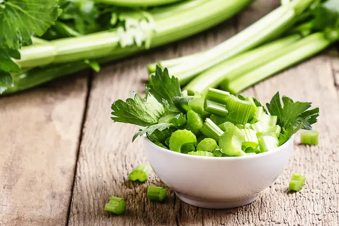 celery cut into small pieces in a bowl on the counter