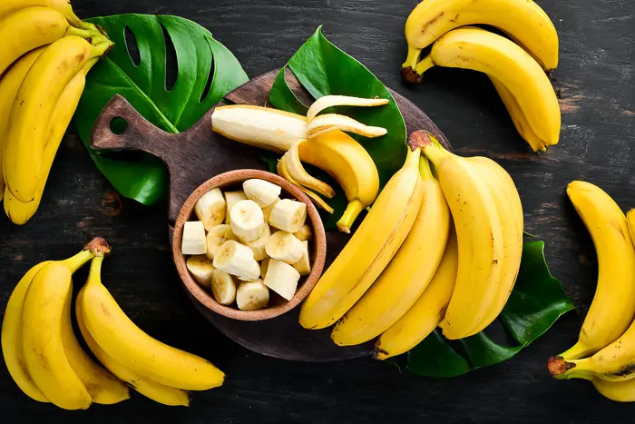 bananas and banana slices in a wood bowl