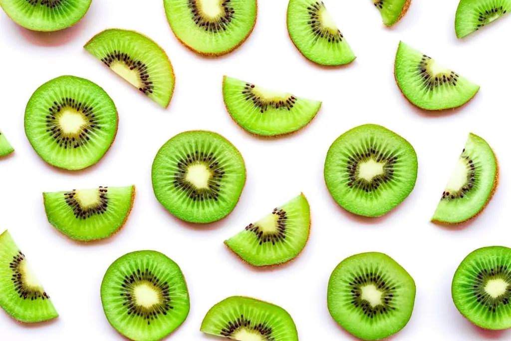 round slices of kiwi on white background