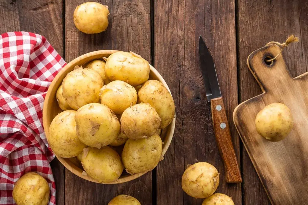 yellow potatoes in bowl with picnic cloth