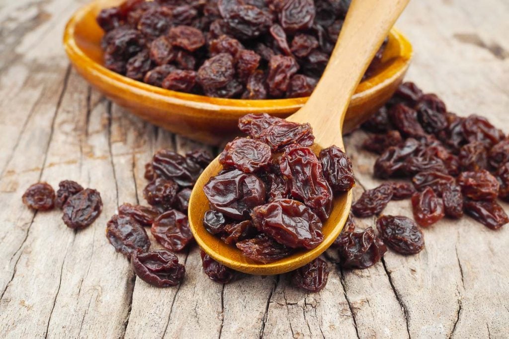 raisins on wooden spoon